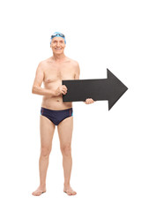 Senior man in a swim trunks holding an arrow