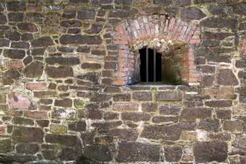old castle window in stone wall, aligned to right