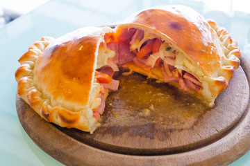 Pizza puff on the wood plate