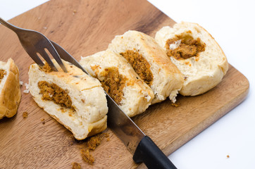 dried shredded pork bread on cutting board on a white background