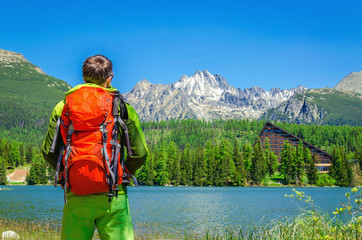 Young man with orange backpack at Strbske Pleso