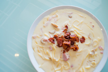 spaghetti extreme cheese carbonara sauce on glass background