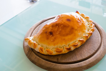 Pizza puff on the wood plate