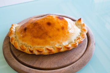 Pizza puff on the wood plate