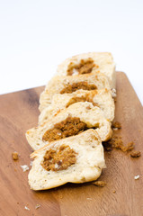 dried shredded pork bread on cutting board on a white background