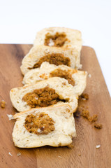 dried shredded pork bread on cutting board on a white background