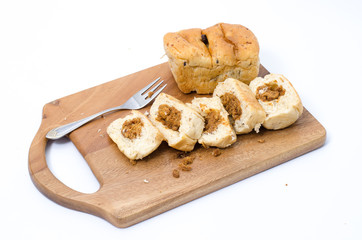 dried shredded pork bread on cutting board on a white background