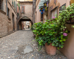 Naklejka premium Ancient medieval street in the downtown of Ferrara city