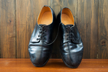 Black shoes on the wooden background