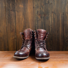 Vintage military boots on wooden background