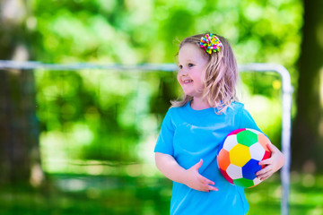 Children playing football outdoors