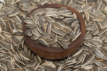 Sunflower seeds in wooden bowl  background
