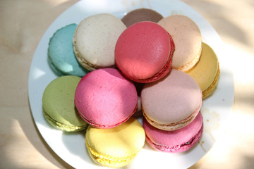 Fototapeta na wymiar Colorful french macaroons on the white plate