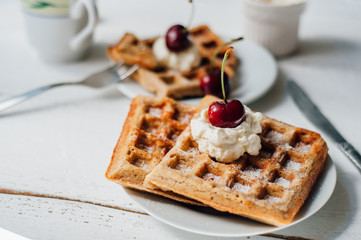 Breakfast with wholegrain waffles and whipped cream
