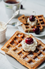 Breakfast with wholegrain waffles and whipped cream