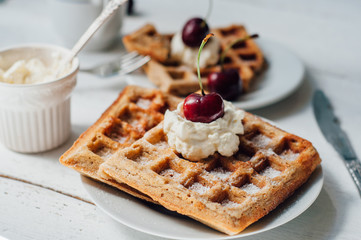 Breakfast with wholegrain waffles and whipped cream