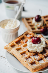 Breakfast with wholegrain waffles and whipped cream
