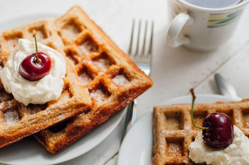 Breakfast with wholegrain waffles and whipped cream