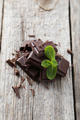 Fresh mint with chocolate on grey wooden background