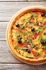 Fresh tasty pizza on grey wooden background