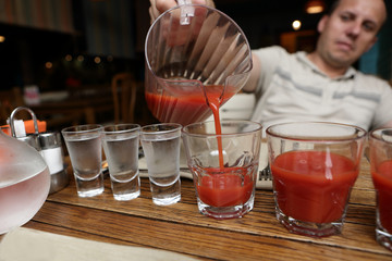 Man pouring tomato juice