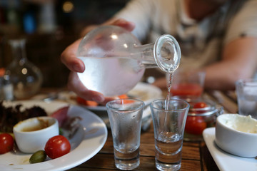 Man pouring vodka from the decanter