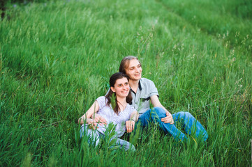 Fototapeta premium Couple in love on meadow on green grass