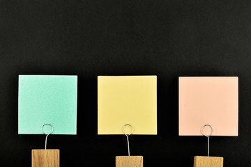 Three paper notes with holder isolated on black for presentation