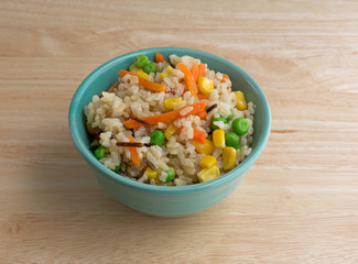 Bowl of wild and brown rice with veggies on table