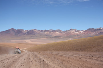 Fototapeta na wymiar Tourist car at the Atacama Desert in Bolivia - Chile mounains