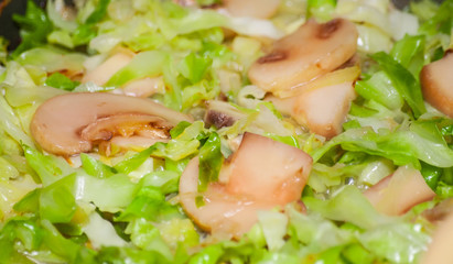 Cooking cabbage with mushrooms in fried pan