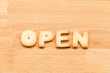 Word open cookie over the wooden background