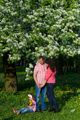 Fototapeta premium family parents and daughter on a walk in a park