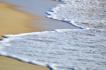 selective focus of close up waves at the beach