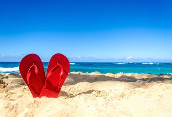 Red flip flops on the sandy beach - 86234062