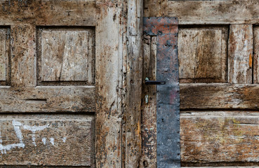 fragment of an old wooden door with old locks
