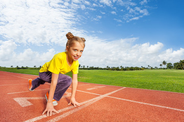 Fototapeta premium Girl in colorful uniform on start ready to run