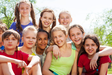 International teenagers sitting close in park