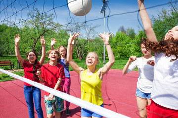 Fototapeta na wymiar Children play actively near the volleyball net