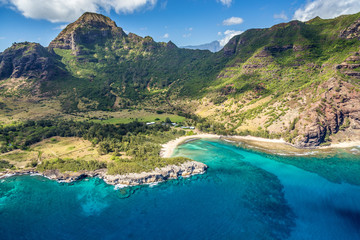 Aerial view of Kauai from a doors off Helicopter tour with lush green mountains and deep blue sea...