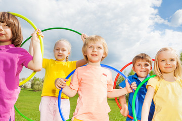 Close-up of children holding hula hoops in park