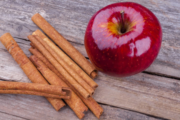 Apple and cinnamon shot from front on on a wooden background at an angle