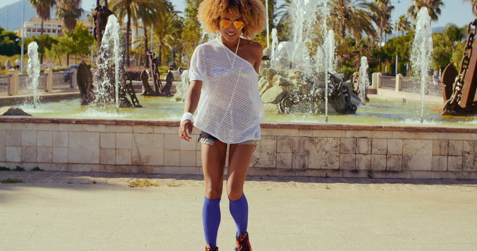 Beautiful Girl with Afro Haircut on Roller Skates