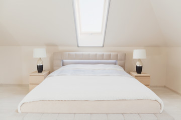 Bright bedroom in the attic