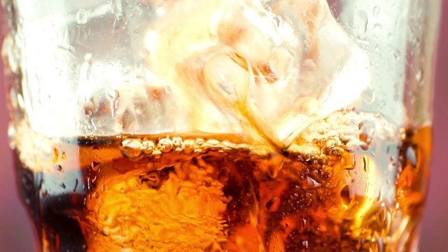 close-up of pouring fresh coke with ice cubes, summer time concept