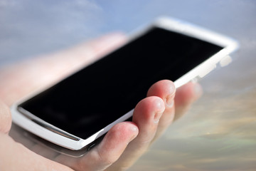 hand holding white mobile phone