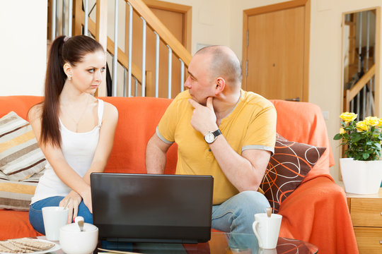 Couple on  couch with  laptop