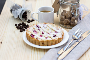Homemade pie with coffee on a wooden background