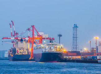 Cargo freight ship with container at harbor terminal..