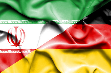 Waving flag of Germany and Iran.